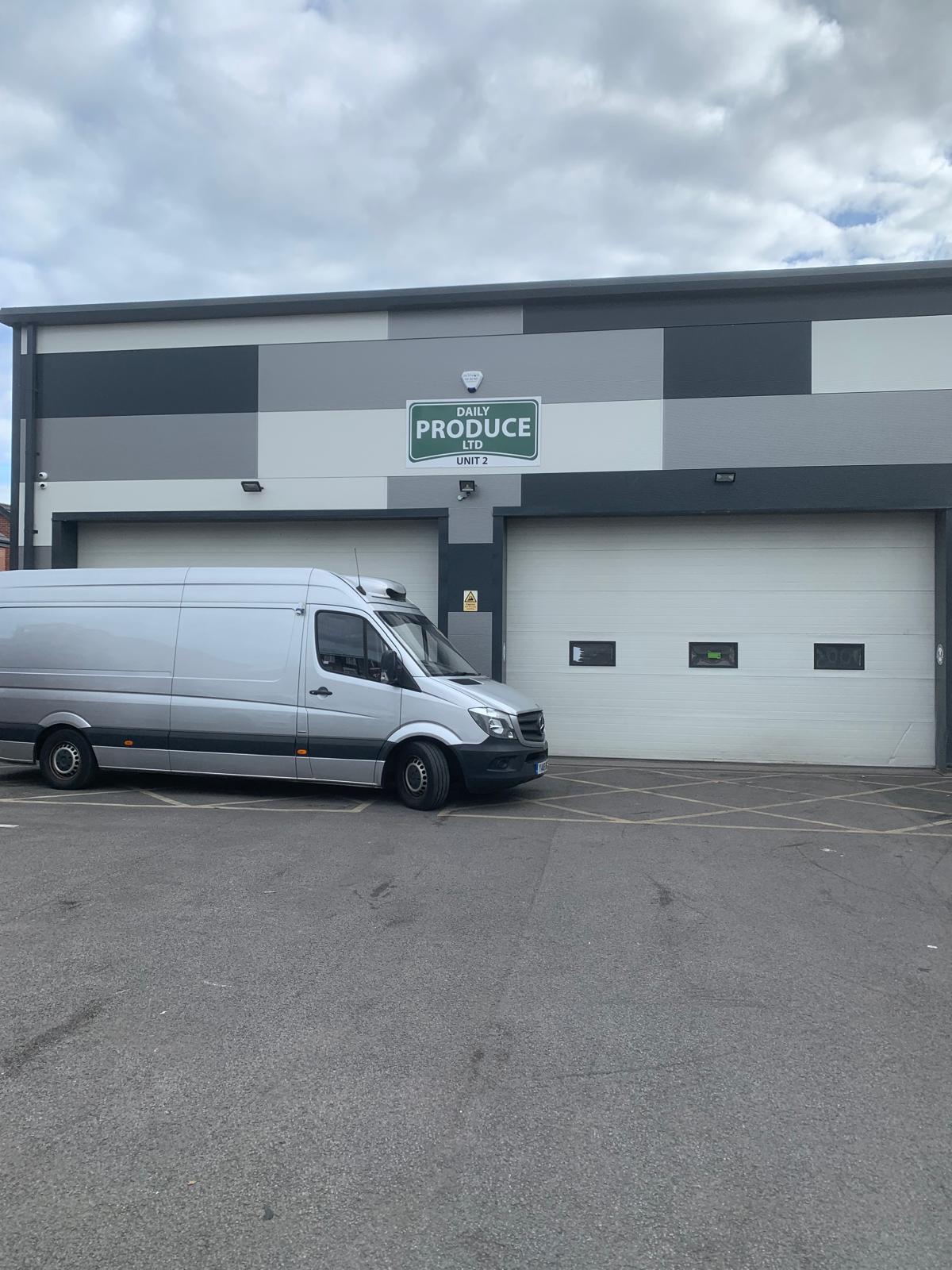 Daily Produce Ltd Unit 2 at Hamer Business Park, Rochdale, with a silver delivery van parked outside the shutter doors
